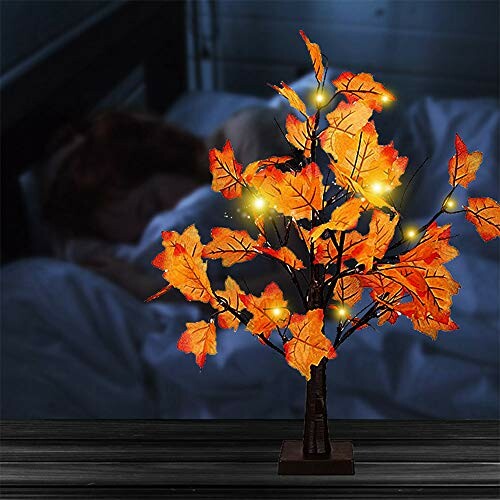 Decorative autumn leaf nightlight with glowing lights.