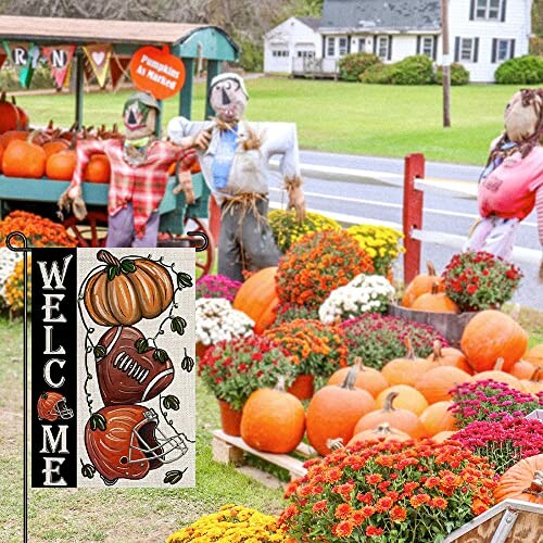 Autumn display with pumpkins, flowers, and scarecrows.