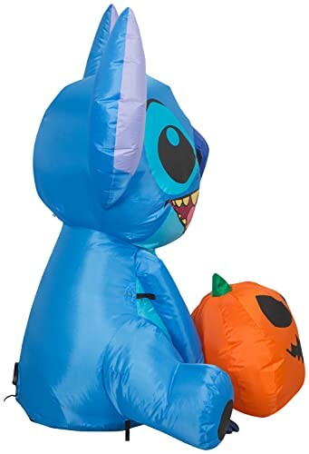 Blue inflatable creature holding an orange pumpkin