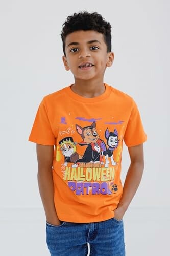 Boy wearing an orange Halloween-themed shirt with cartoon characters