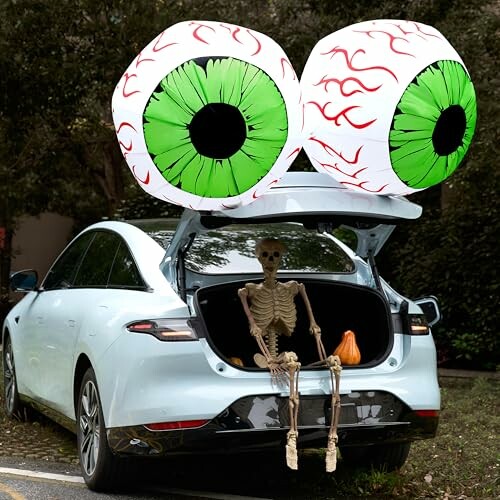 Car trunk decorated with large eyes and skeleton for Halloween.