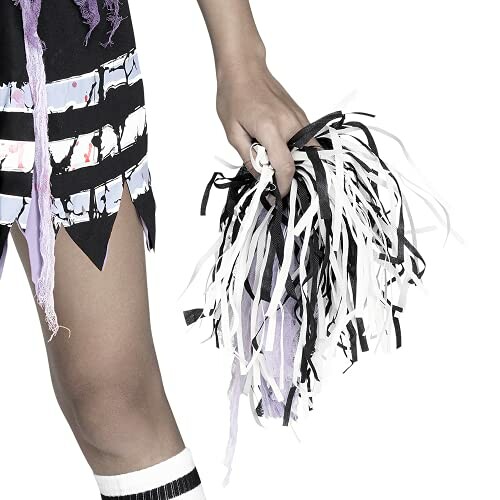 Person holding black and white pom-poms.