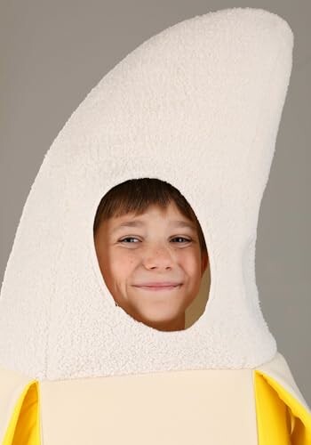 Child smiling in banana costume.