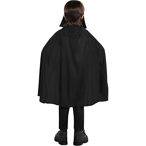 Child wearing a black cape costume from the back.