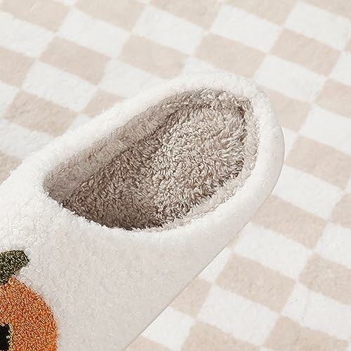 Close-up of a cozy fleece slipper on a checkered background