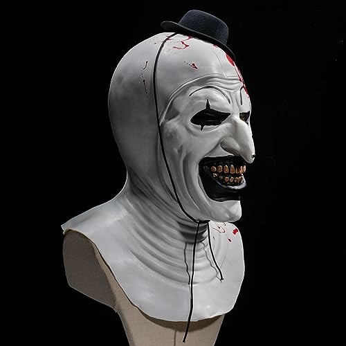 Creepy clown mask with a small hat and painted features