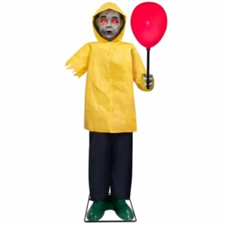 Creepy clown figure in yellow raincoat holding red balloon