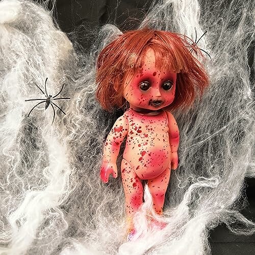 Creepy doll with red spots and spiders in white web