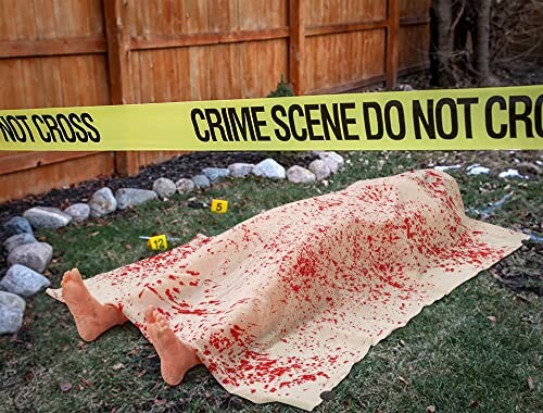 Crime scene with a covered body and evidence markers.