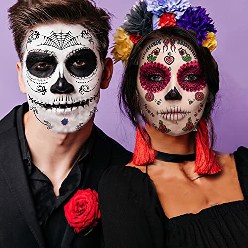 Two people with Day of the Dead face paint and colorful accessories.