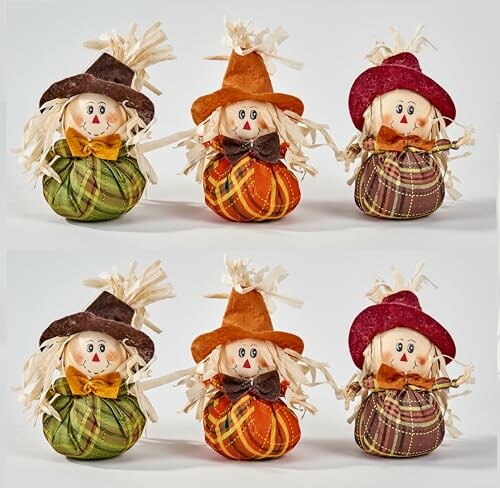 Colorful decorative scarecrow dolls dressed in autumn-themed outfits.