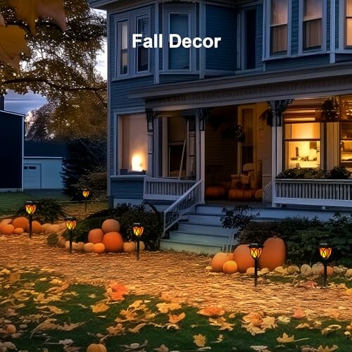 House with fall decorations and pumpkins on a lawn