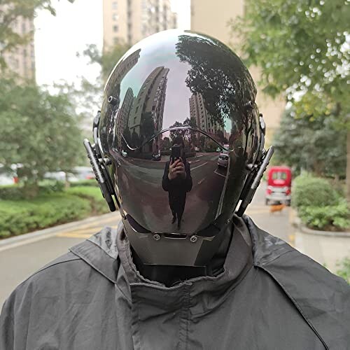 Person wearing a reflective futuristic helmet in an urban setting