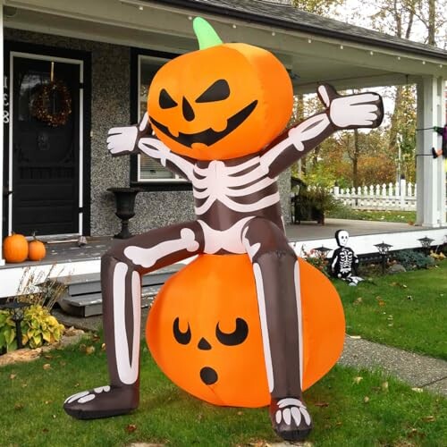 Inflatable skeleton with pumpkin head on front lawn.