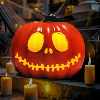 Glowing Jack-o'-lantern surrounded by candles.