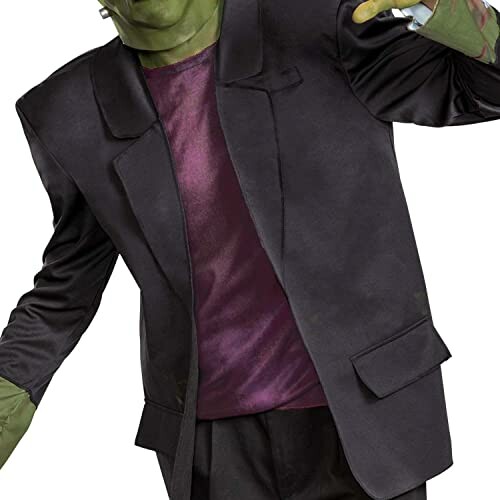 Person in a green monster costume with a black jacket and purple shirt.