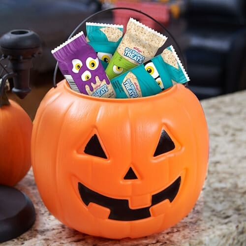 Pumpkin bucket filled with Halloween-themed Rice Krispies treats.