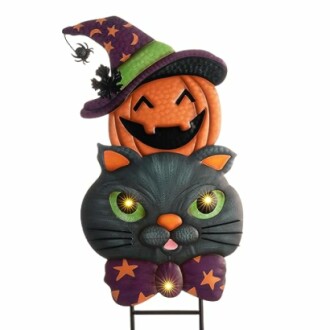 Halloween decoration with black cat and pumpkin wearing a witch hat.