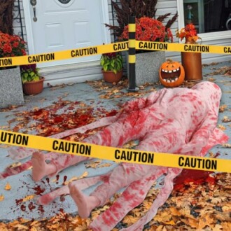 Halloween decor with fake bloody body and caution tape