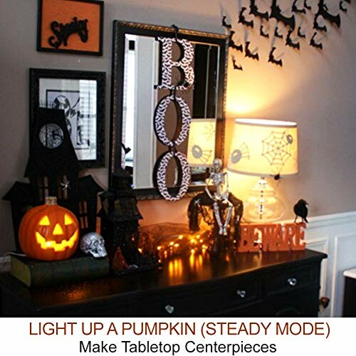 Halloween-themed dresser with pumpkin, BOO sign, and decorations.