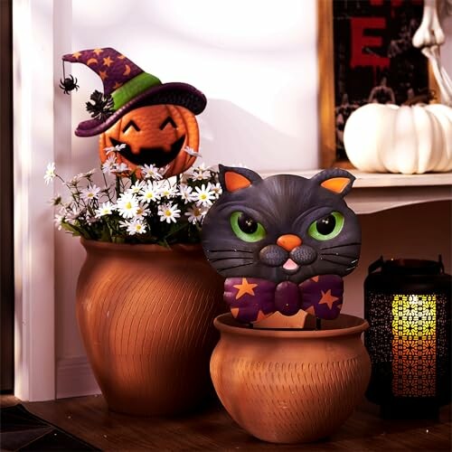 Halloween decorations with pumpkin and black cat figures in pots