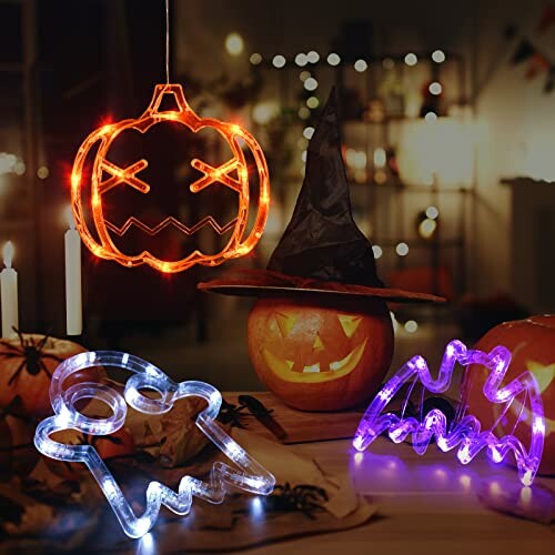 Halloween decorations with pumpkin, ghost, bat, and witch hat lighting.