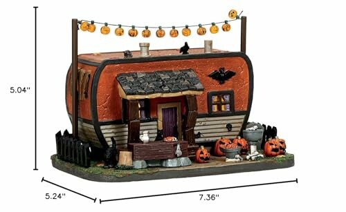 Halloween-themed decorative trailer with pumpkins and lights