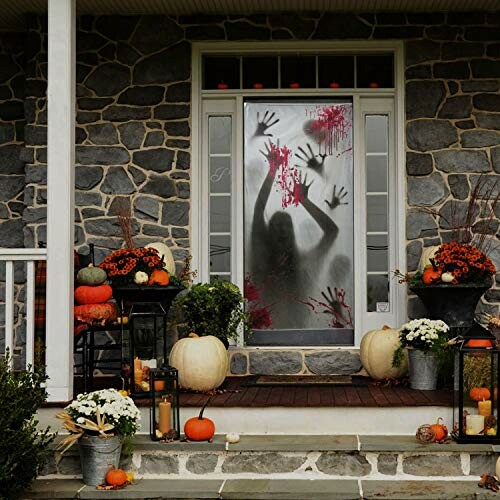 Halloween door with silhouette and pumpkins.