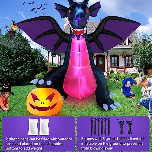 Large inflatable dragon with wings and a pumpkin in front of a house, children in costumes nearby.