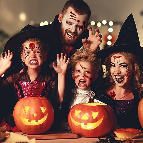 Family in Halloween costumes with carved pumpkins.