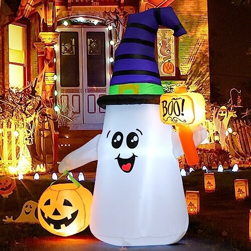 Inflatable ghost with witch hat holding pumpkin and boo sign.