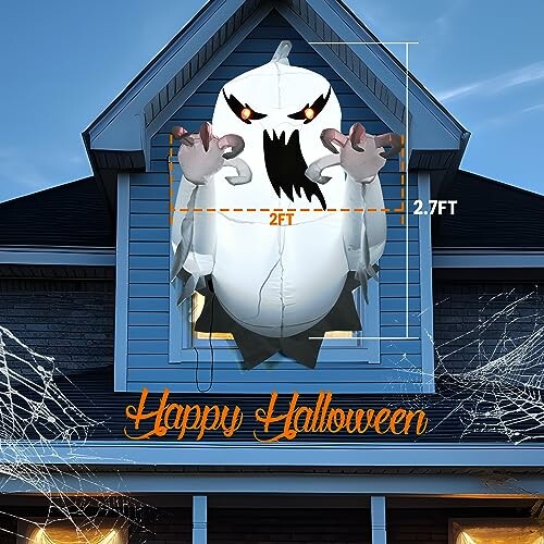 Inflatable ghost decoration in a house window with 'Happy Halloween' text.