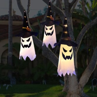 Halloween ghost lanterns hanging from a tree