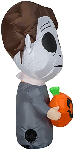 Inflatable Halloween character holding a pumpkin.