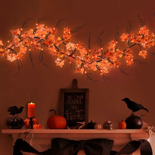 Halloween-themed mantel with orange lights, pumpkins, and crows.