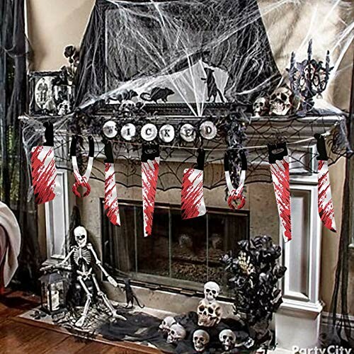 Halloween mantel with skeletons, skulls, and hanging bloody tools