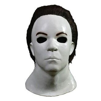 White Halloween mask with black hair and eye holes.