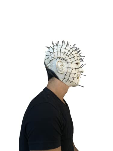 Person wearing a pinhead mask from the side