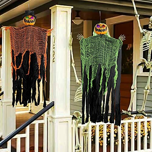 Halloween decorations with hanging pumpkin figures and skeleton on porch.