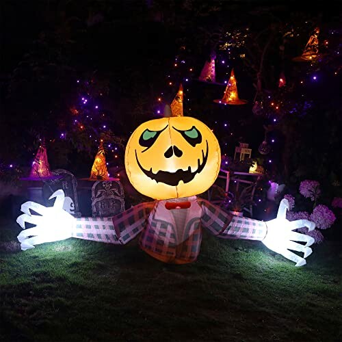 Inflatable pumpkin decoration with glowing hands and Halloween lights.