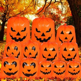 Stack of orange pumpkin leaf bags in autumn forest