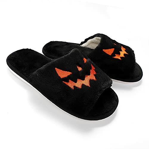 Black slippers with orange pumpkin face design