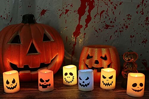 Halloween pumpkins and spooky candles with blood splatter backdrop.