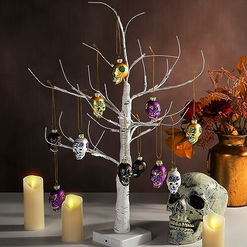 Decorative tree with colorful skull ornaments and candles.