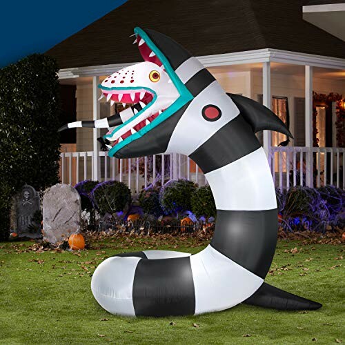 Black and white striped inflatable snake decoration on lawn for Halloween.