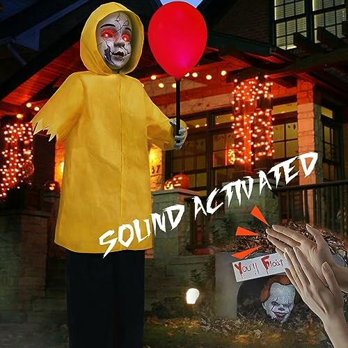 Sound activated Halloween decoration with red balloon and spooky house backdrop.