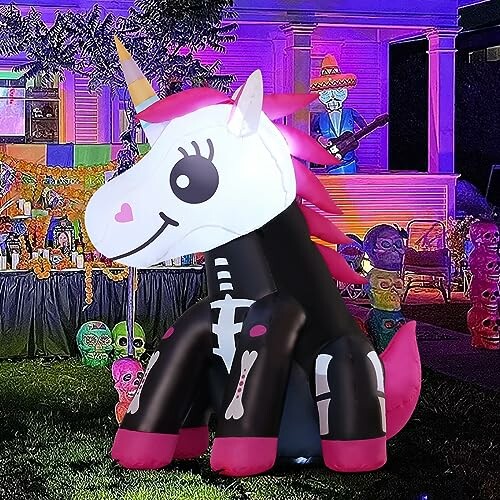 Inflatable unicorn skeleton decoration at a colorful Halloween scene.