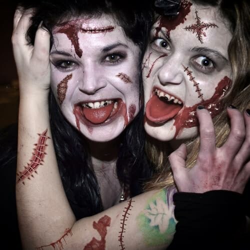 Two people with horror-themed zombie makeup and costumes.