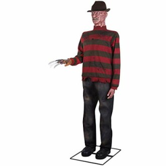 Life-sized figure of a horror movie villain with clawed glove and striped sweater.