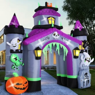 Inflatable Halloween castle decoration with ghosts, spider, and pumpkin.